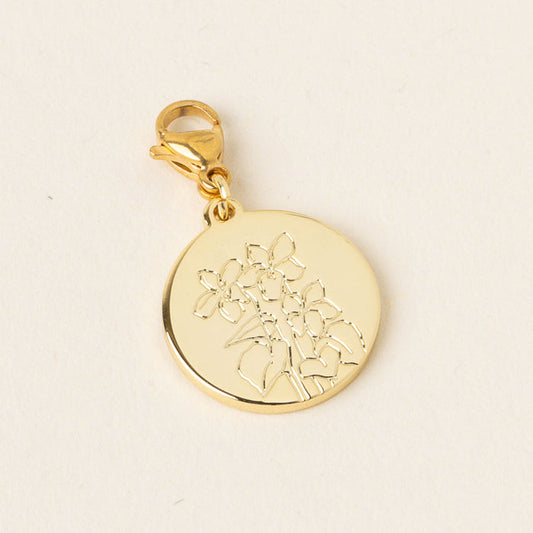 The March Jewelry Birth Flower Charm Gold by the-darling-effect is a round gold pendant with an engraved floral design and a lobster clasp, photographed against a plain light background.