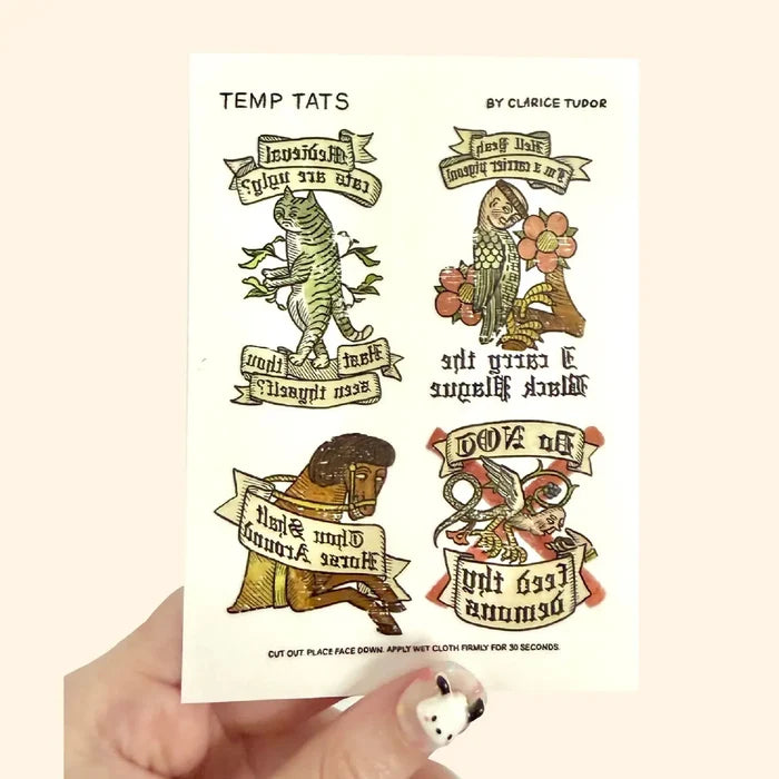 Hand holds Forager Provisions Medieval & Folklore Gift Set with 4 medieval art temporary tattoos, unique history gift idea.