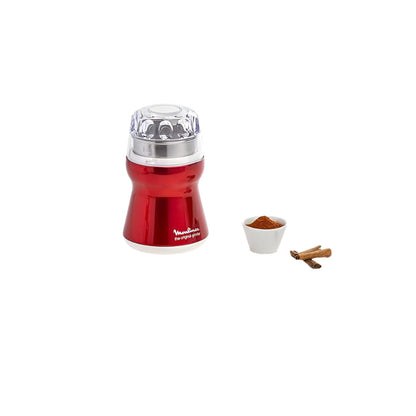 Red and silver pepper grinder with a small bowl of spices and cinnamon sticks on a white background