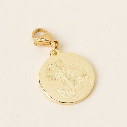 The-darling-effect's November Jewelry Birth Flower Charm Gold is a round pendant engraved with three dandelion flowers, featuring a lobster clasp for easy attachment to chains or bracelets.