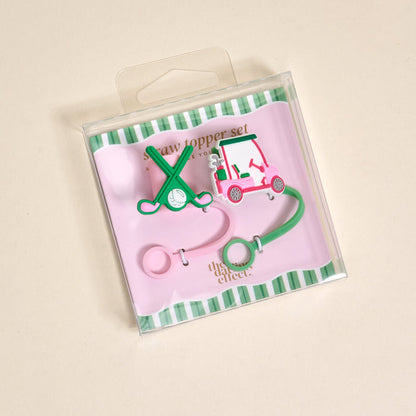 The Darling Effect Par-tee Pack Straw Topper Set includes two silicone toppers—one shaped like crossed golf clubs with a ball, the other a pink golf cart—on a pink and green striped card in a clear box.