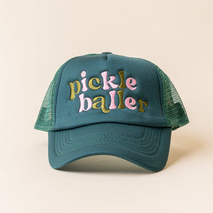 The Darling Effect Pickleballer Trucker Hat features trendy green mesh and “pickle baller” embroidered in yellow and pink on the front. Displayed against a plain light background, it’s perfect for fans of stylish embroidered hats.