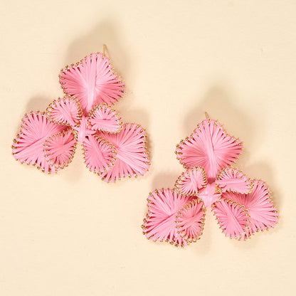 The Darling Effect's Pink Main Character Earrings are lightweight, three-petaled flower earrings with gold detailing—perfect for daily wear and shown on a beige background.