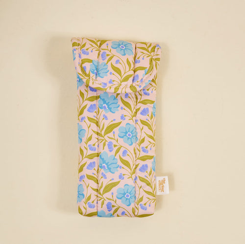 The Darling Effect's Poppin' Petals Aqua Puffy Sunglasses Case is a soft, machine-washable quilted case featuring blue flowers and green leaves on light beige, displayed against a plain background.