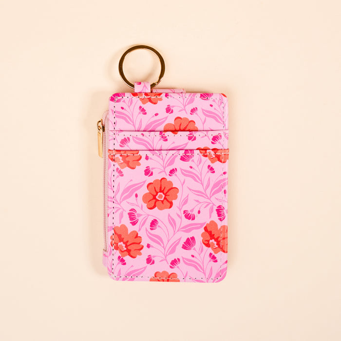 The Darling Effect's Poppin' Petals Hot Pink Keychain Wallet features a floral design and gold keychain, keeping your essentials stylishly organized in a slim profile.