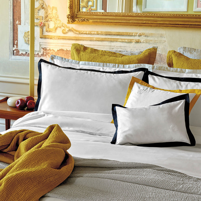 Prado midnight pillowcase sham on a bed in a bedroom setting.