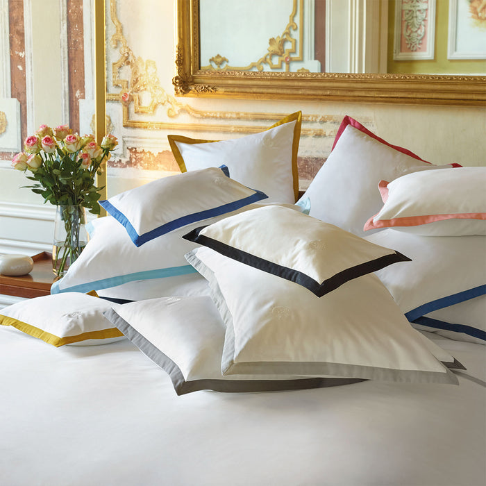 Set of Prado pillowcases sham on a bed in a luxurious bedroom.