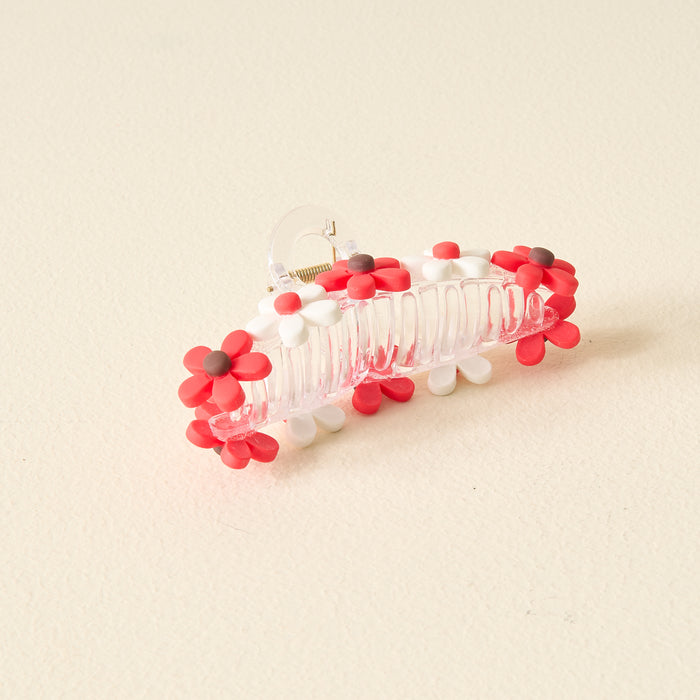 The Darling Effect's Red Game Day Daisy Claw Clip features red and white daisy-shaped charms with brown centers—a fun, spirited accessory to show off your school colors on Game Day.