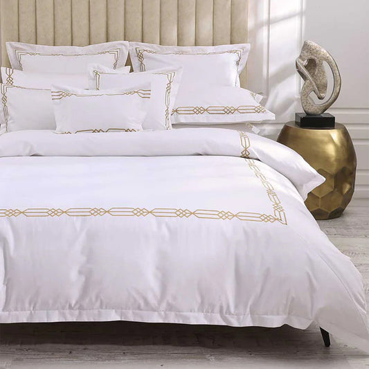 Renata Gold Duvet Cover Set on a bed in a bedroom setting.