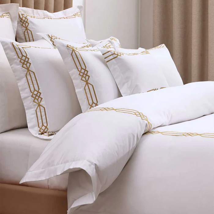 Renata Gold Duvet Cover Set on a beige sofa.