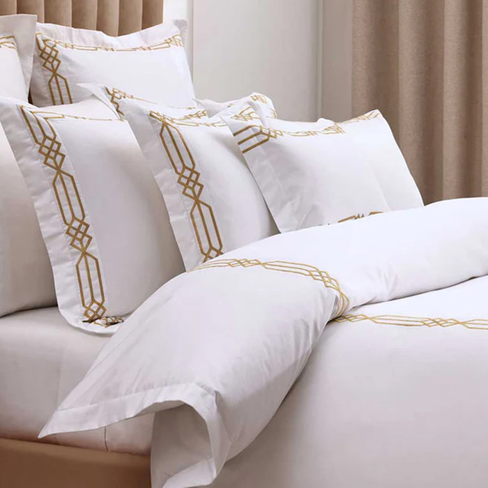 Renata Gold Pillowcase on a bed in a bedroom setting.
