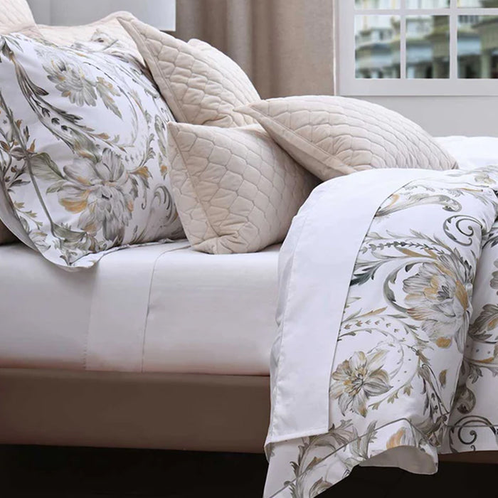 Ruben Duvet Cover Set on a white bed in a room with a window.