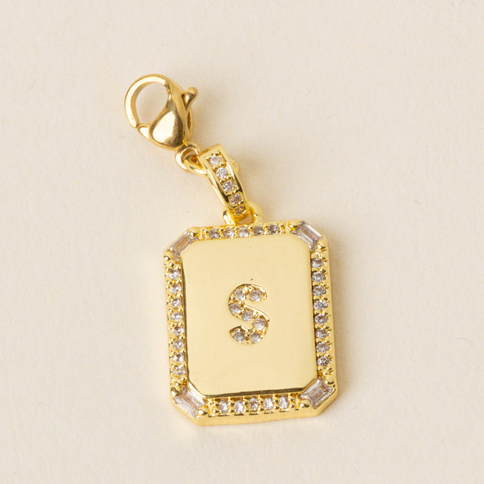 The-darling-effect S Jewelry Charm Initial Letter Gold features a gold-plated brass pendant with a diamond-studded border and an 'S' center on a lobster clasp—ideal for personalizing your Initial Letter Jewelry Charms collection.