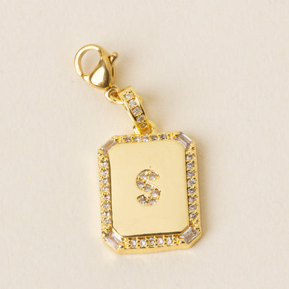 The-darling-effect S Jewelry Charm Initial Letter Gold features a gold-plated brass pendant with a diamond-studded border and an 'S' center on a lobster clasp—ideal for personalizing your Initial Letter Jewelry Charms collection.