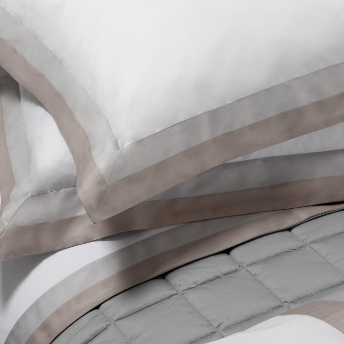 Close-up of Samuele pillowcase sham and duvet cover on a neutral background