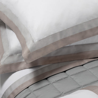 Close-up of Samuele pillowcase sham and duvet cover on a neutral background
