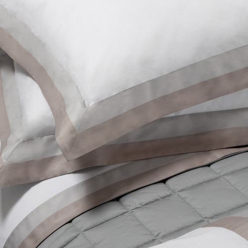 Close-up of Samuele pillowcase sham and duvet cover on a neutral background