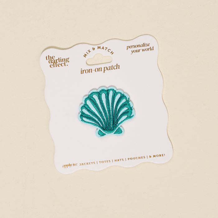 The Seashell Mix & Match Iron-On Patch by The Darling Effect is shown on a white, scalloped card reading “the darling effect, iron-on patch, personalize your world”—ideal for customizing jackets with colorful style.