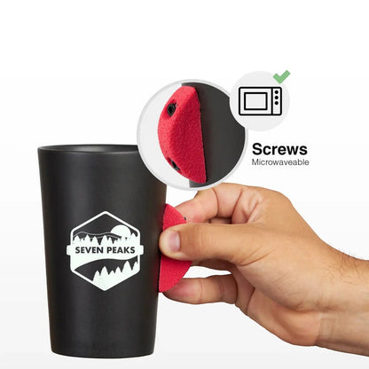 A hand attaches a red grip to a Seven Peaks Climber 7a mug; microwave-safe, ideal gift for rock climbers and hikers.