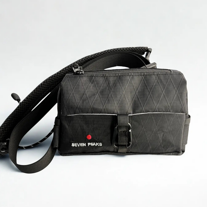 Forager Provisions LTD Seven Peaks all-black water-resistant fanny pack with adjustable strap and carabiner detail.