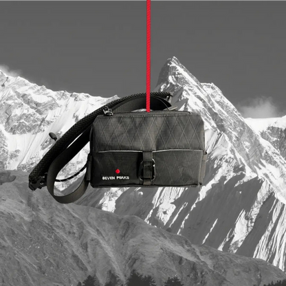 Forager Provisions LTD Seven Peaks all-black water-resistant fanny pack hanging against a mountain backdrop.