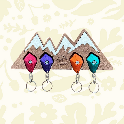 Forager Provisions LTD Seven Peaks mountain-shaped resin key holder with four colorful climbing hold keychains