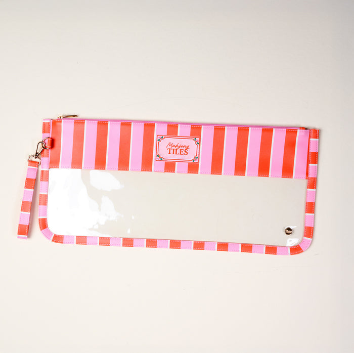 The Darling Effect Sicily Stripes Pink Mahjong Tile Keeper Pouch features pink and white stripes, a wrist strap, clear front panel, and a "Tiles" label at the top center. It's displayed on a plain light-colored surface.