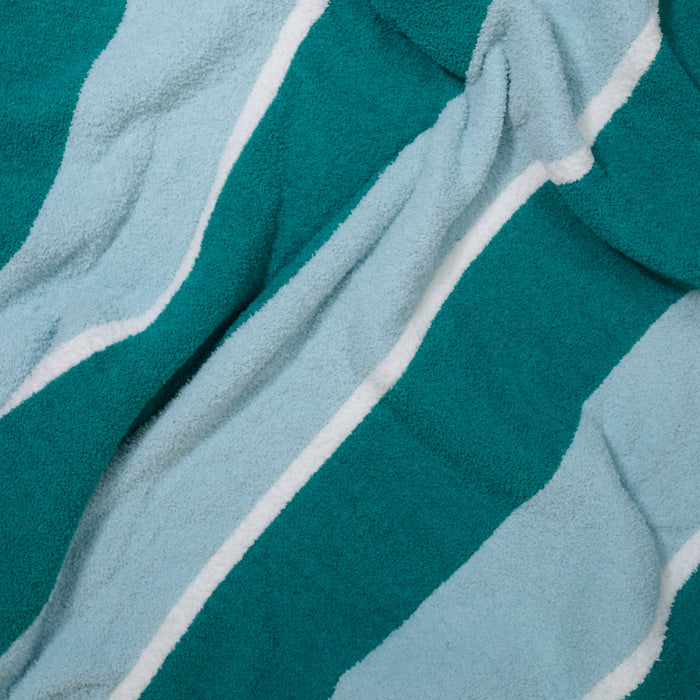 A close-up of The Darling Effect Sicily Stripes Teal Cozy Dreams Luxe Blanket highlights its ultra-soft, textured fabric with wide teal and light blue stripes separated by thin white lines, designed for ultimate comfort.