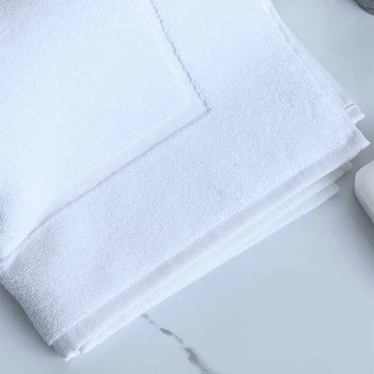 Signature Bath Mat White on a marble surface