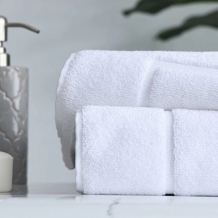 Signature Bath Mat White on a marble surface with a soap dispenser in the background.