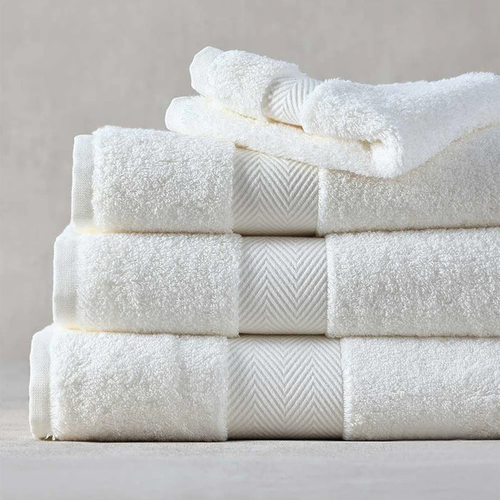 Stack of Signature Towels Ivory on a neutral background