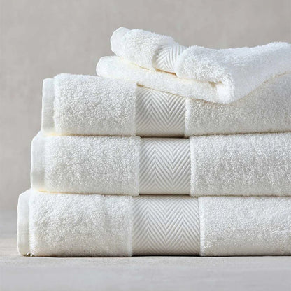 Stack of Signature Towels Ivory on a neutral background
