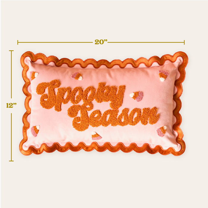 Add festive flair to your sofa with The Darling Effect's Spooky Season Scalloped Rectangle Throw Pillow—20" x 12", peach with orange scalloped edges, “Spooky Season” in textured orange letters, plus candy corn accents.