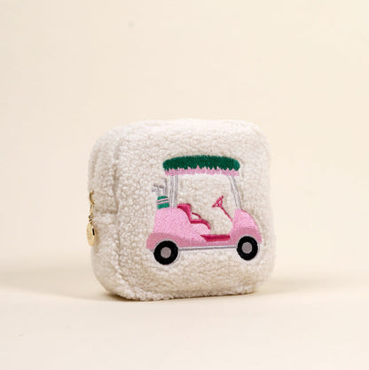 The Darling Effect's Square Golf Cart Teddy Pouch features fuzzy white sherpa fabric with a pink embroidered golf cart and clubs—an adorable addition to your teddy pouches or accessory collection.