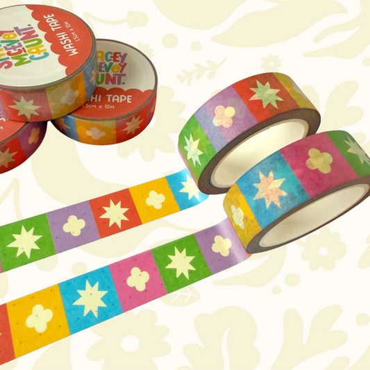 Four Rainbow Medieval Grid Tile Pattern Washi Tapes by Stacey McEvoy Caunt unspooled on a colorful patterned surface.