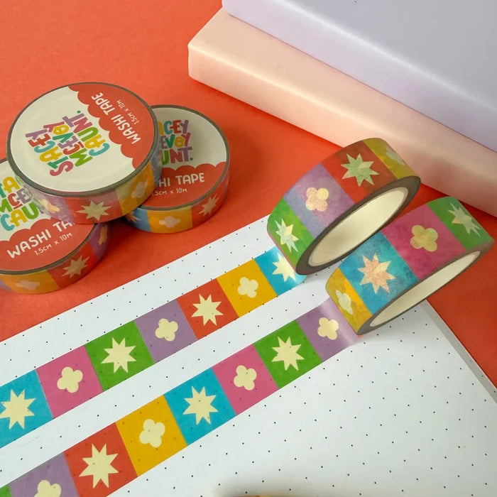 Stacey McEvoy Caunt Rainbow Medieval Grid Tile Pattern washi tape rolls, partially unrolled, on white paper background.