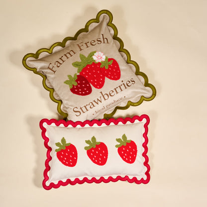 The Darling Effect’s Strawberries Scalloped Rectangle Throw Pillow features scalloped edges and a charming “Farm Fresh Strawberries” design, making it the perfect accent to brighten your home with cozy style.