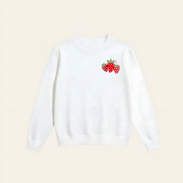 The Darling Effect’s Strawberry Patch Refined Knit Sweater is a classic white long-sleeve, featuring a small embroidered trio of red strawberries with green leaves on the left chest.
