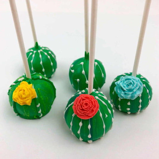 Five green succulent-themed cake pops decorated with white drips. One topped with a yellow flower, one with a red flower, and another with a blue flower.