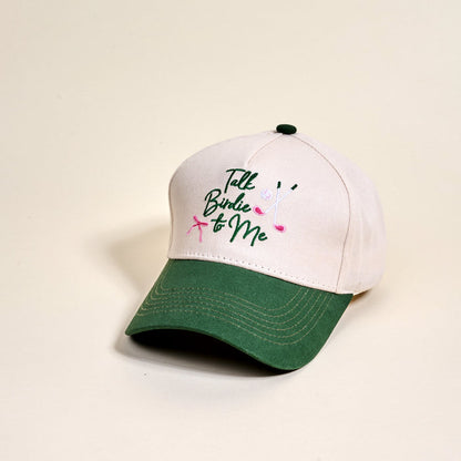 The Darling Effect’s Talk Birdie to Me Classic Canvas Hat features cream and green colors, relaxed fit, and embroidered text with golf clubs for a casual look.