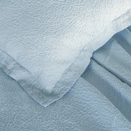 Tamara-Blue decorative pillowcase on top of a tamara blue bed spread