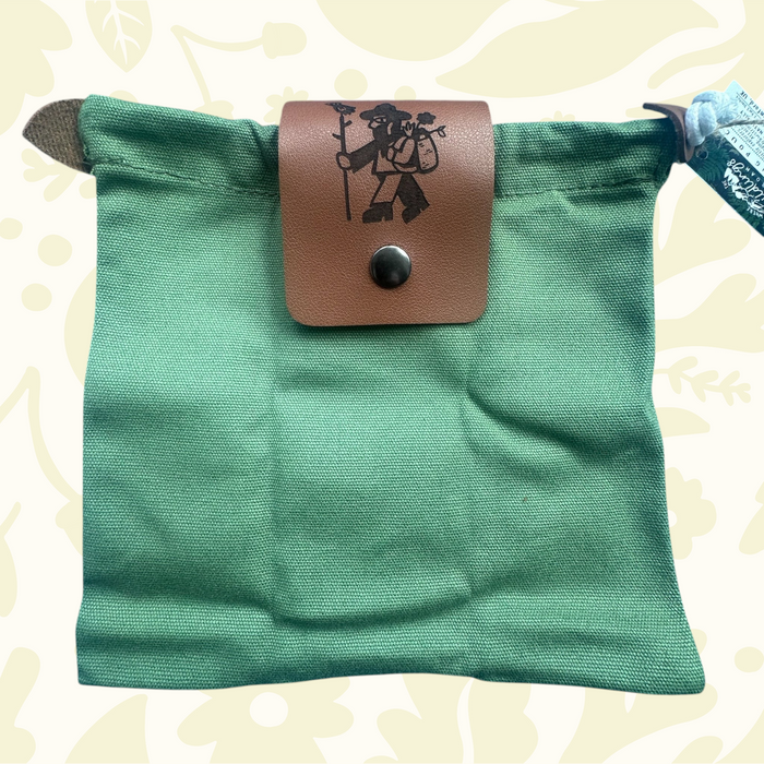 Forager Provisions LTD green up-cycled cotton canvas pouch with a branded vegan leather flap in a woodland setting
