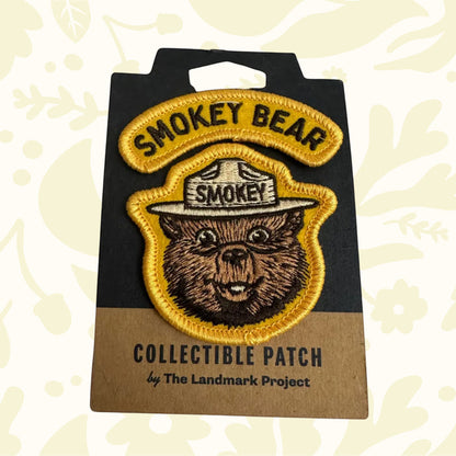 Forager Provisions LTD Smokey Bear embroidered varsity patch with yellow border on branded display card