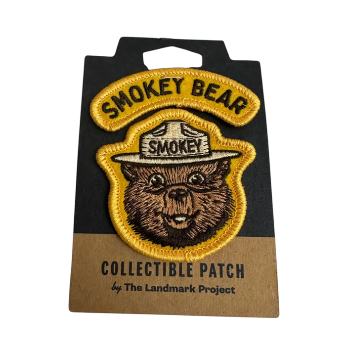 Forager Provisions LTD embroidered Smokey Bear varsity patch with yellow border on branded backing card.