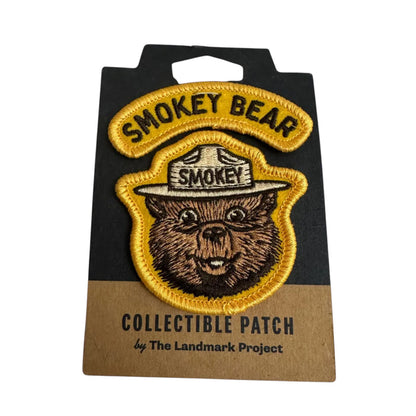 Forager Provisions LTD embroidered Smokey Bear varsity patch with yellow border on branded backing card.