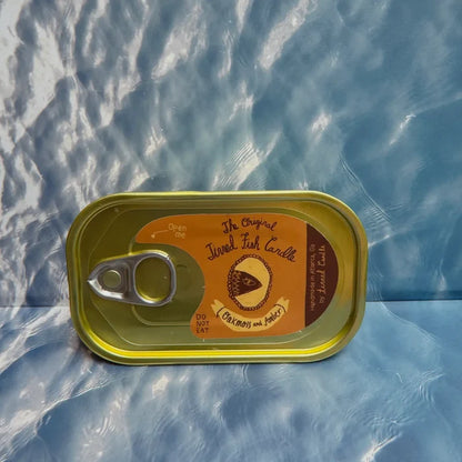 The Original Tinned Fish Candle Oakmoss & Amber by Tinned Candle displayed on blue marbled surface, home decor accent, gift idea.