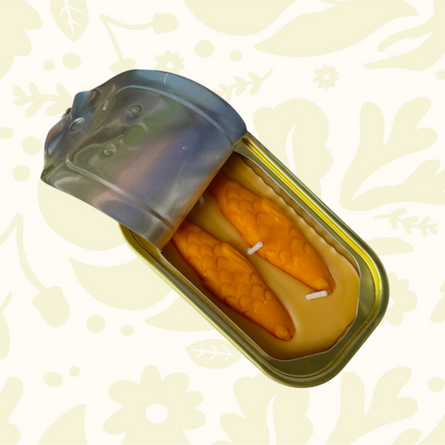 Forager Provisions LTD The Original Tinned Fish Candle in sandalwood, shaped like two orange fish inside a metal tin.