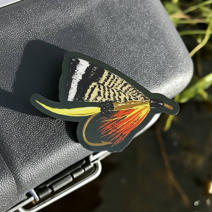Forager Provisions LTD vinyl sticker featuring a detailed vintage-style fishing fly illustration on a cooler