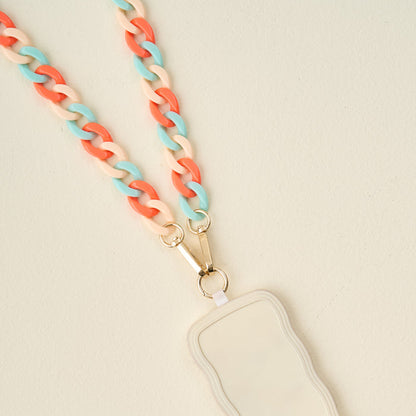 The Darling Effect Tri Coastal Hold the Phone Crossbody Chain features a chunky coral, cream, and teal design with gold hardware and a cream badge holder—combining fashion and function as both a lanyard and crossbody phone chain.