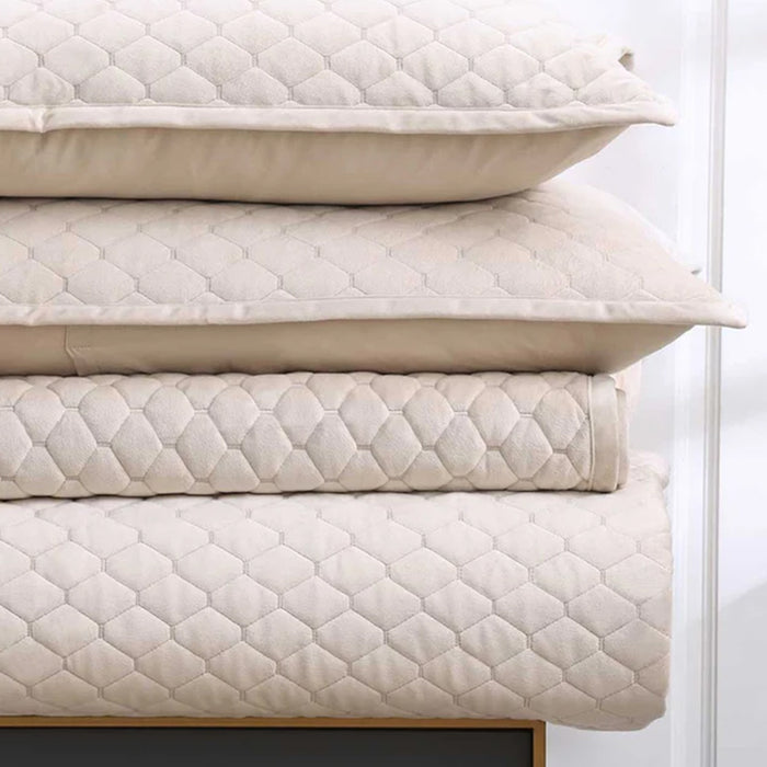 Stack of Turner latte pillows cushions on Turner Bedrunner Latte, on a wooden frame against a white background